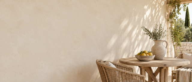 Design placeholder, not a photograph of Lemon Drops: a generated image of a small table and a bowl of lemons against a lime-washed wall.